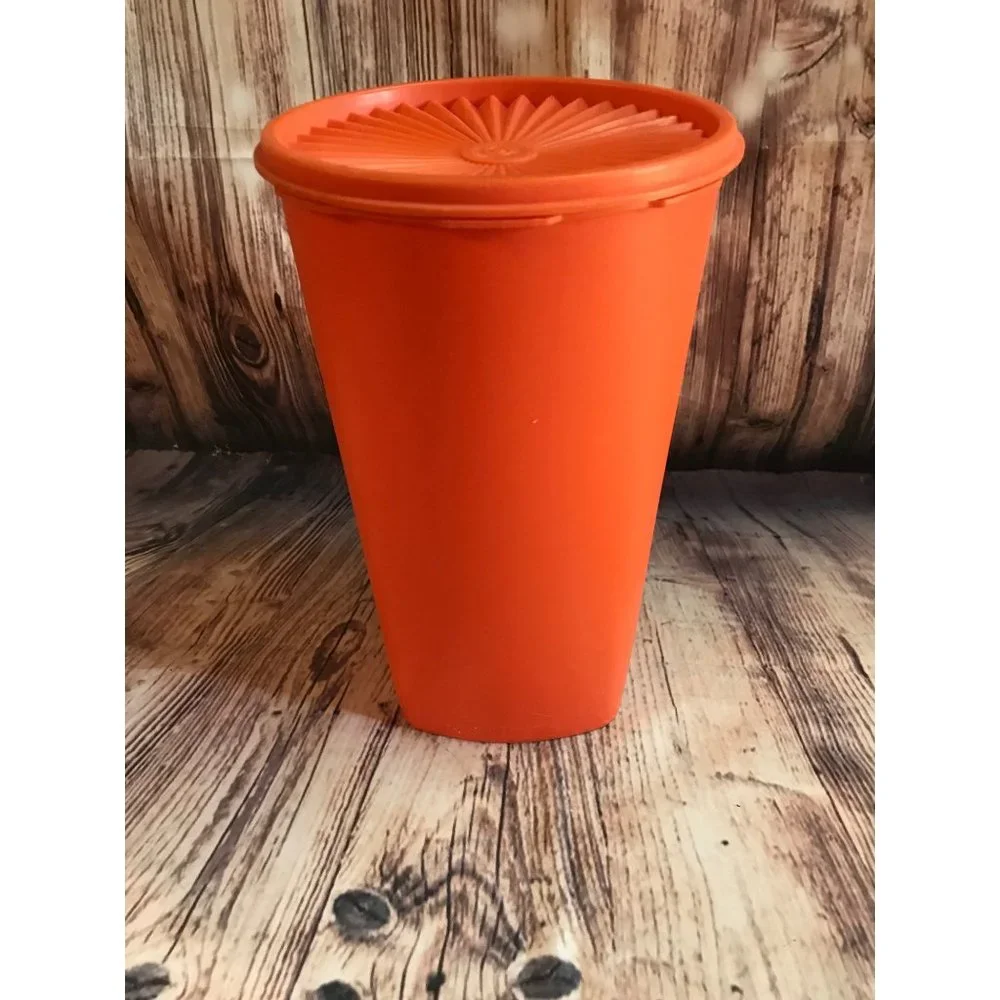 Vintage 70’s tangerine orange Tupperware canister with lid.